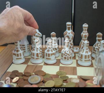 moving the pieces of chess with my hand. Concept, deciding about where to invest Stock Photo