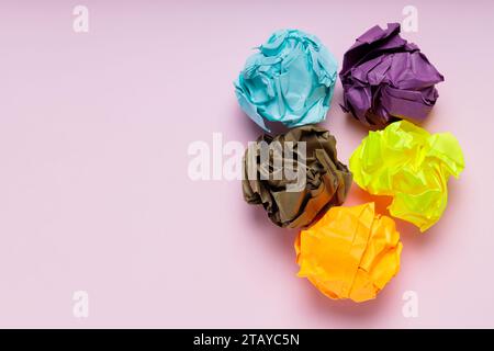 Crumpled Colorful Paper Balls on Pink Background, Uselessness Concept Stock Photo