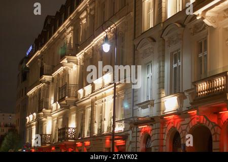 XIX century building in Warsaw, Poland, lighted with white and red lights Stock Photo