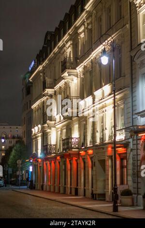 XIX century building in Warsaw, Poland, lighted with white and red lights Stock Photo