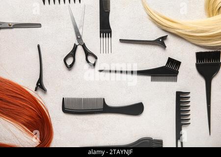 Different hair with set of hairdresser's tools on grey background Stock Photo