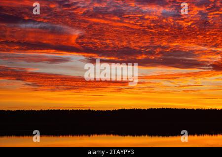 Beautiful sky background with clouds after sunset. Red yellow sky. Stock Photo