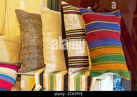 Decorative colorful soft textile pillows on a shelf interior Stock Photo