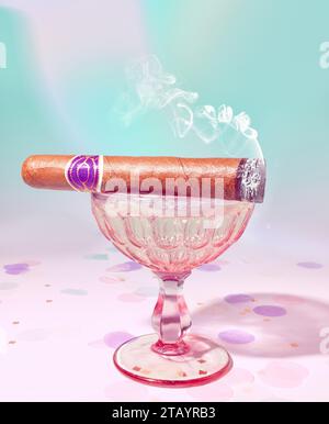 A Lit Cigar Smoking Cigar Sitting on a Crystal Pink Vintage Coupe Champagne Glass Stock Photo