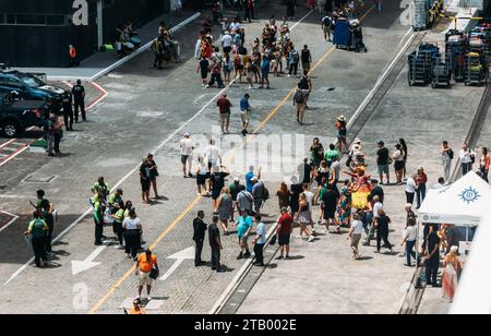Salvador, Brazil - December 2, 2023: High perspective view of people dressed in traditional Bahia clothes and playing drums to welcome cruise ship Stock Photo