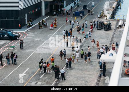 Salvador, Brazil - December 2, 2023: High perspective view of people dressed in traditional Bahia clothes and playing drums to welcome cruise ship Stock Photo