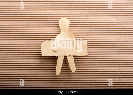Paper man shape holding burnt note paper in hand Stock Photo