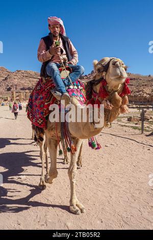 Camel and rider on his phone, Petra Archaeological Park, a UNESCO World Heritage Site, 7 New Wonders of the World, Jordan. Stock Photo