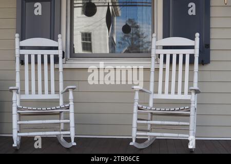 Two white rocking chairs on the front porch. Stock Photo