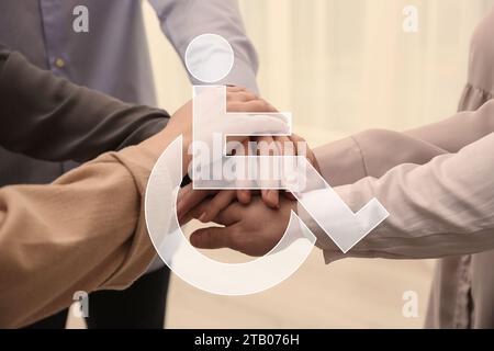 Inclusive workplace culture. International symbol of access. People holding hands together, closeup Stock Photo