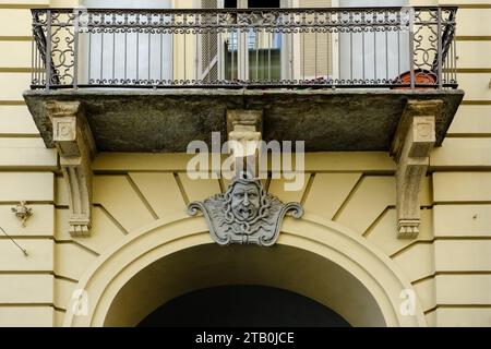 Carved face on Via Giuseppe Garibaldi, a pedestrian street, among the main ones in the historic center of Turin, Piedmont Region, Italy Stock Photo
