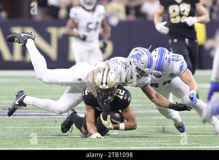 New Orleans, USA. 03rd Dec, 2023. Detroit Lions safety Brian Branch (32) and linebacker Malcolm Rodriguez (44) both tackle New Orleans Saints wide receiver Chris Olave (12) during a National Football League game at Caesars Superdome in New Orleans, Louisiana on Sunday, December 3, 2023. (Photo by Peter G. Forest/Sipa USA) Credit: Sipa USA/Alamy Live News Stock Photo