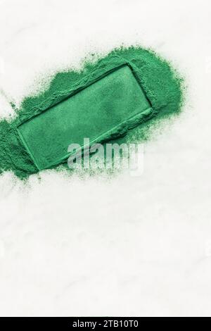 Scattered natural spirulina green algae powder on white background with highlighted space for text. blank lay for text, product presentation Stock Photo