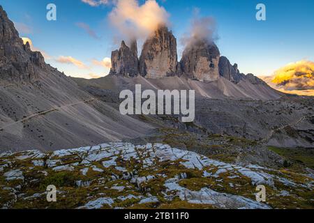Autumn sunrise paints a mesmerizing tableau over Tre Cime di Lavaredo in the Dolomites, Italy. Nature's splendor on full display, a tranquil moment ca Stock Photo