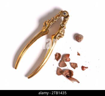 Large nut with vintage nutcracker, isolated on white Stock Photo