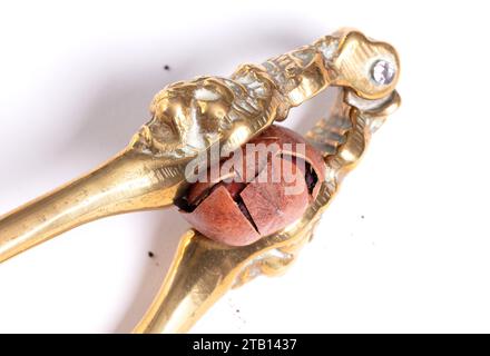 Large nut with vintage nutcracker, isolated on white Stock Photo