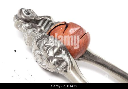 Large nut with vintage nutcracker, isolated on white Stock Photo