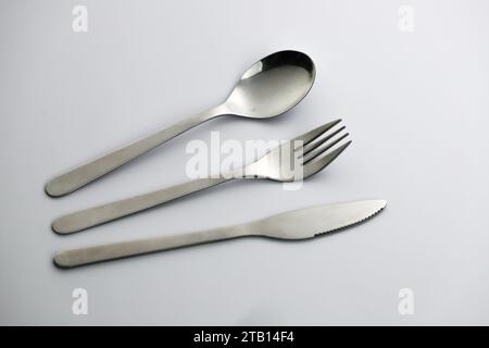 Spoon, knife and fork on a table Stock Photo