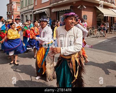 the folk dance ensemble Cuniburo Cultural from Ecuador performs traditional dance in the town street during the International Folklore Festival in Rus Stock Photo