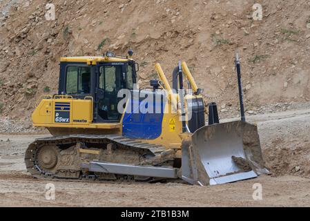 Luxembourg City, Luxembourg - Yellow and blue bulldozer Komatsu D65WX on construction site. Stock Photo
