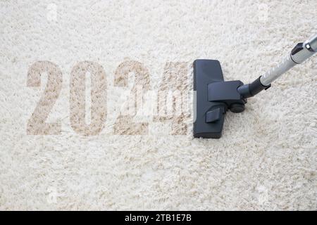 home cleaning with vacuum cleaner and copy space for a text, new year 2024 Stock Photo