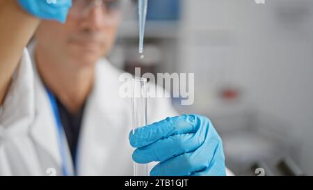 Passionate middle age man scientist working in lab, pouring liquid into test tubes amidst medical research Stock Photo