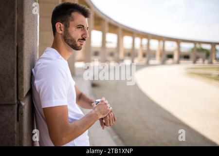 Young fitness man runner checking time on smart watch. Stock Photo