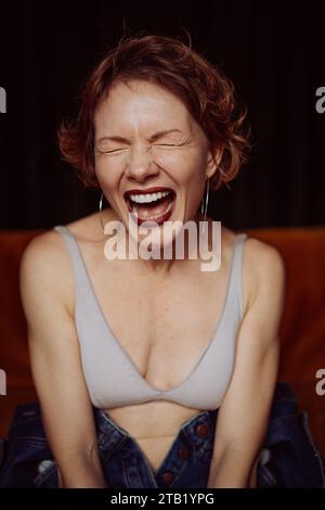 Young brunette woman screams, emotional portrait. Stock Photo