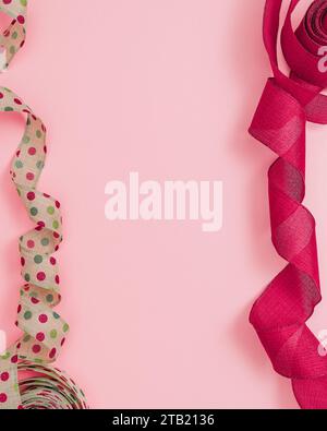 Red and Polka Dot Ribbon on Pink Background with Copy Space Stock Photo