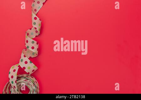 Polka Dot Ribbon on a Red Background with Copy Space Stock Photo