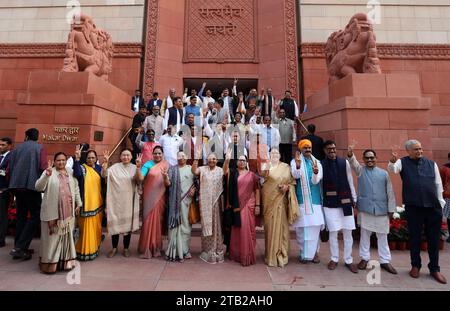 New Delhi, India. 04th Dec, 2023. Members of Parliament (lawmakers) from the Bharatiya Janata Party show victory signs standing outside the new Parliament building on the first day of the Parliament winter session 2023, at Parliament House. Prime Minister Modi said the opposition should learn from defeat and consider this a golden opportunity and move forward with positivity this session. Credit: SOPA Images Limited/Alamy Live News Stock Photo