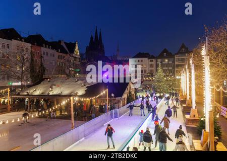 ice skating rink on the Christmas market at the Heumarkt in the historic town, view to the cathedral, Cologne, Germany. Eislaufbahn auf dem Weihnachts Stock Photo