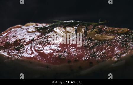 Raw tomahawk steak with seasonings on pan. Stock Photo