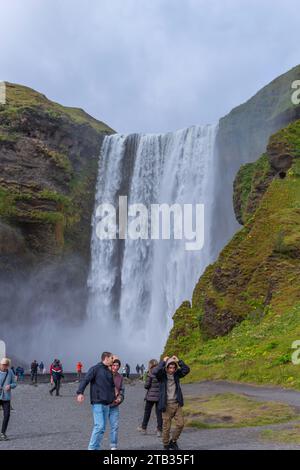 Skogar Iceland - July 28, 2023: Tourists visiting Skogafoss waterfall in south Iceland Stock Photo