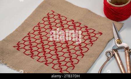 Crafting Elegance: Hand-Sewn Pattern on Cotton Fabric Stock Photo - Alamy