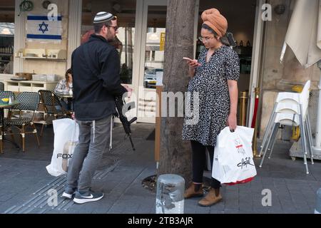 Shoresh, Israel. 04th Dec, 2023. An Israeli civilian couple with their M-16 assault rifle as they wait for a table at a popular Jerusalem cafe on December 4, 2023. Many Israelis, both off-duty soldiers and civilians, are carrying their weapons as the war continues against Hamas in the Gaza Strip and to combat attacks wherever they may occur inside Israel, such as the attack at a Jerusalem bus stop a few days ago, which was carried out by Hamas supporters from East Jerusalem. Photo by Jim Hollander/UPI Credit: UPI/Alamy Live News Stock Photo