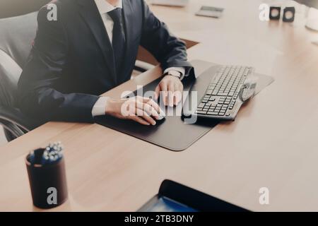 Focused businessman using computer at a sleek office desk Stock Photo