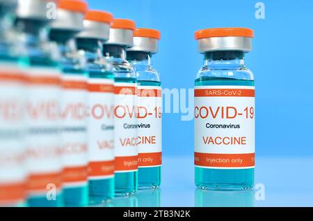 Row Bottles with covid-19 vaccine. Medicine and corona virus infection concept. Close up Stock Photo