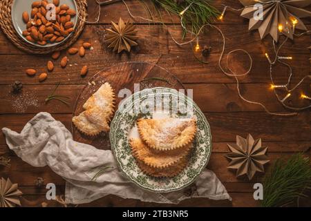A crescent-shaped pastry whose filling is made of eggs and almonds wrapped in crispy dough, cut in an artisanal way and sprinkled with sugar. Stock Photo