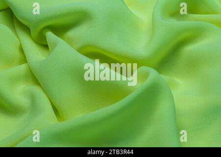 Green fabric cloth texture for background and design, crumpled pattern of silk or linen. Stock Photo