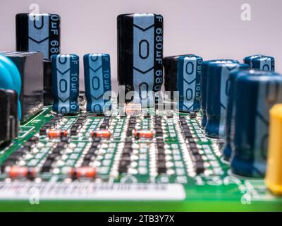 Green printed circuit board with electronic components. Selective focus. Stock Photo