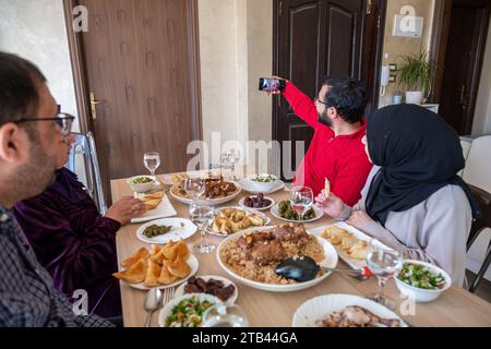 Family taking selfie together while having dinner Stock Photo