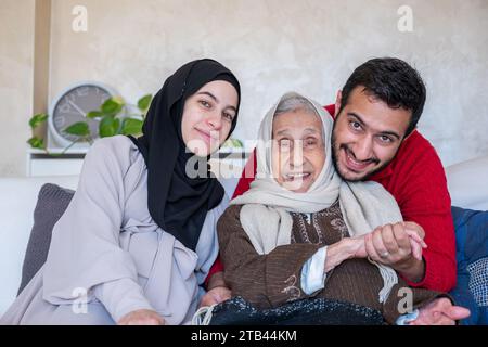 mother father and grandmother as a happy family in modern living room Stock Photo