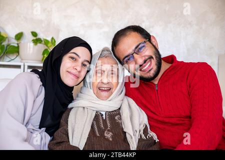 mother father and grandmother as a happy family in modern living room Stock Photo