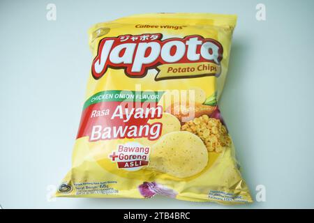 Potato chips Japota snack with onion chicken flavor on a white background. Bekasi, Indonesia, December 5, 2023 Stock Photo