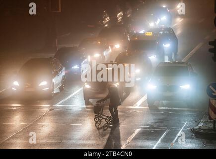 City centre traffic, fog, traffic jam, autumn, winter, evening rush hour traffic, Alfredstraße B224, pedestrian crossing, Essen, NRW, Germany, Stock Photo