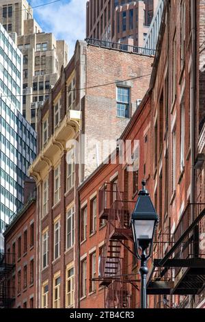 New York City, NY, USA-October 15, 2023; Low angle view of some of the historic buildings on Stone Street of former New Amsterdam in Manhattan with mo Stock Photo