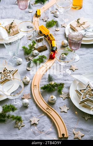 Festive Christmas place setting with small wooden railway Stock Photo