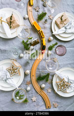 Festive Christmas place setting with small wooden railway Stock Photo