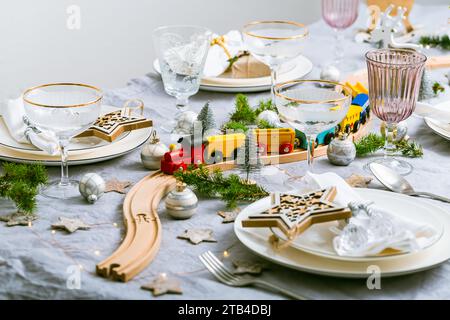Festive Chriustmas place setting with small wooden railway Stock Photo